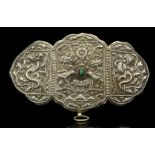 A SILVER WOMAN'S DRESS ORNAMENT OR BELT BUCKLE, TIBET From the Tingri region of Mount Everest,