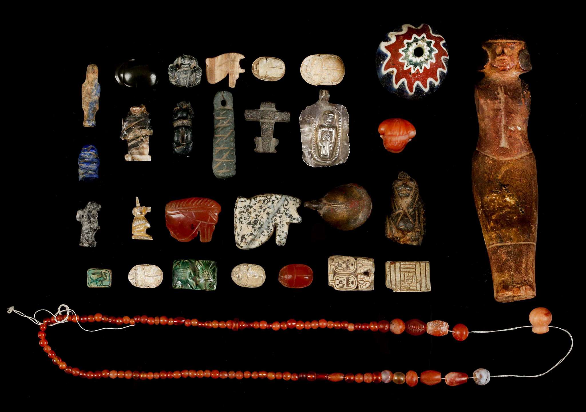 A GROUP OF EGYPTIAN HARDSTONE AND BRONZE AMULETS AND FRAGMENTS Second Intermediate Period to