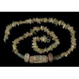 AN ISLAMIC GLASS AND HARDSTONE BEAD NECKLACE Circa 8th-11th Century A.D. Composed of irregular