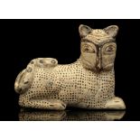 AN ITALO-CORINTHIAN STYLE POTTERY FIGURAL VESSEL In the shape of a crouching lion, the tail curled