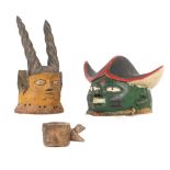 TWO YORUBA 'GELEDE' HELMET MASKS, NIGERIA One with green face and pointed hat, 20cm high; another