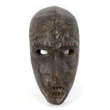 A LEGA MASK, DEMOCRATIC REPUBLIC OF CONGO With hollow eyes and elaborate headband carved on the