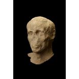 A ROMAN LIMESTONE MALE PORTRAIT HEAD Circa 1st Century A.D. Naturalistically carved, depicting an