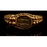 A ROMAN GOLD AND GLASS INTAGLIO RING Circa 2nd-4th Century A.D. The gem engraved with two draped