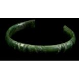 A EUROPEAN BRONZE PENANNULAR BRACELET Late Bronze Age, circa 8th-7th Century B.C. Finely decorated