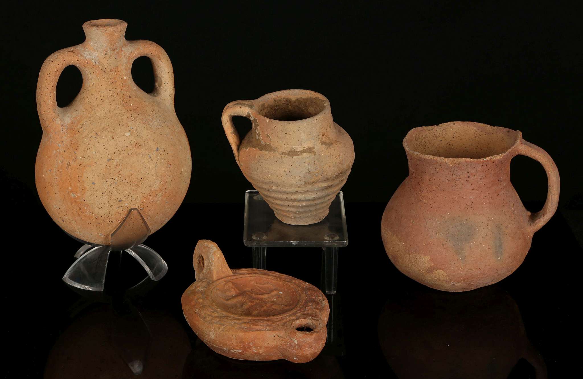 FOUR ANCIENT TERRACOTTA VESSELS Bronze Age to Roman Period, circa 3200 B.C. to 4th Century A.D.