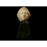 A ROMAN MARBLE HEAD OF ATHENA Circa 2nd Century A.D. Wearing the Corinthian helmet, with wavy