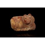 A SUMERIAN RED STONE STAMP SEAL Jemdet Nasr Period, circa 3100-2900 B.C. Carved in the shape of a
