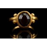 A ROMAN GOLD AND BANDED AGATE RING Circa 2nd-3rd Century A.D. The oval gem set in a plain bezel,