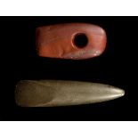 TWO BRITISH POLISHED STONE TOOLS Neolithic Period, circa 3rd Millennium B.C. Including a dark red