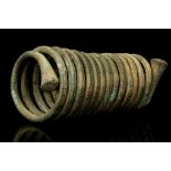 A KALABARI BRONZE SPIRAL ARMLET, NIGERIA Of round cross-section, the coils decreasing in size from