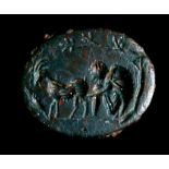 A ROMAN BLOODSTONE INTAGLIO Circa 1st-3rd Century A.D. Engraved with a shepherd milking a goat under