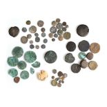 A GROUP OF ANCIENT BRONZE AND SILVER COINS AND A TERRACOTTA MOULD Circa 1st-7th Century A.D. and