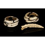 TWO BOAR'S TUSK BANGLES, PAPUA NEW GUINEA The tusks inserted into one another and fixed with long