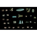 TWENTY-NINE EGYPTIAN GLAZED COMPOSITION AMULETS, BEADS AND FRAGMENTS Late Period, circa 664-332 B.C.