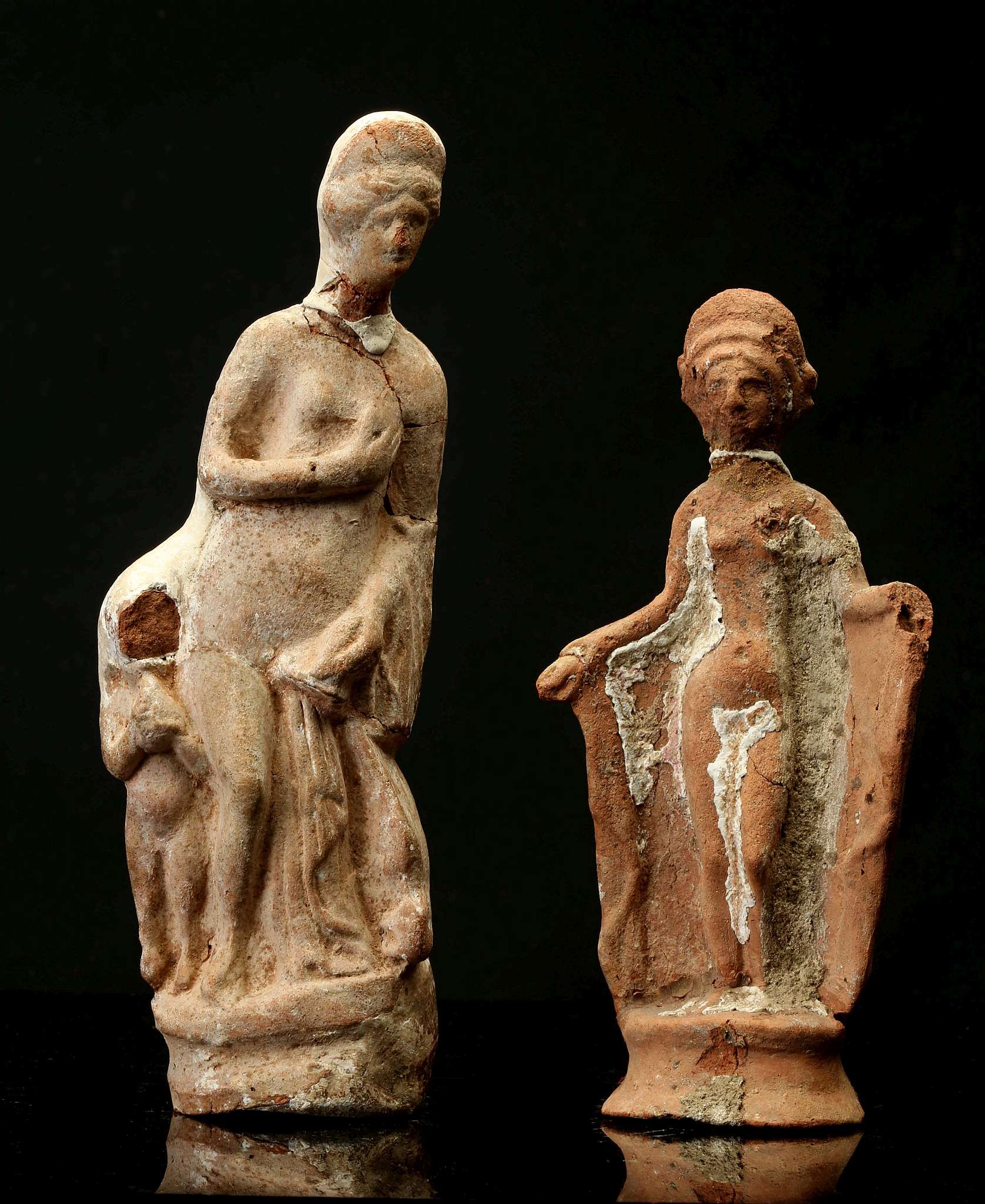 TWO ROMAN TERRACOTTA FIGURES OF APHRODITE Circa 1st-2nd Century A.D. One depicted nude bringing