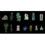 THIRTEEN EGYPTIAN GLAZED COMPOSITION AND STEATITE AMULETS Late Period, 664-332 B.C. Including an