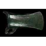 A EUROPEAN BRONZE SOCKETED AXEHEAD Late Bronze Age, circa 8th-7th Century B.C. With curved blade,