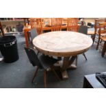 A reclaimed timber circular dining table on swan n