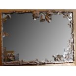 An Art Nouveau style wall mirror with an ornate me