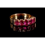 An 18ct rose gold and ruby five stone ring.