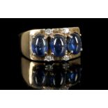 An 9ct gold, cabouchon sapphire and diamond set ri