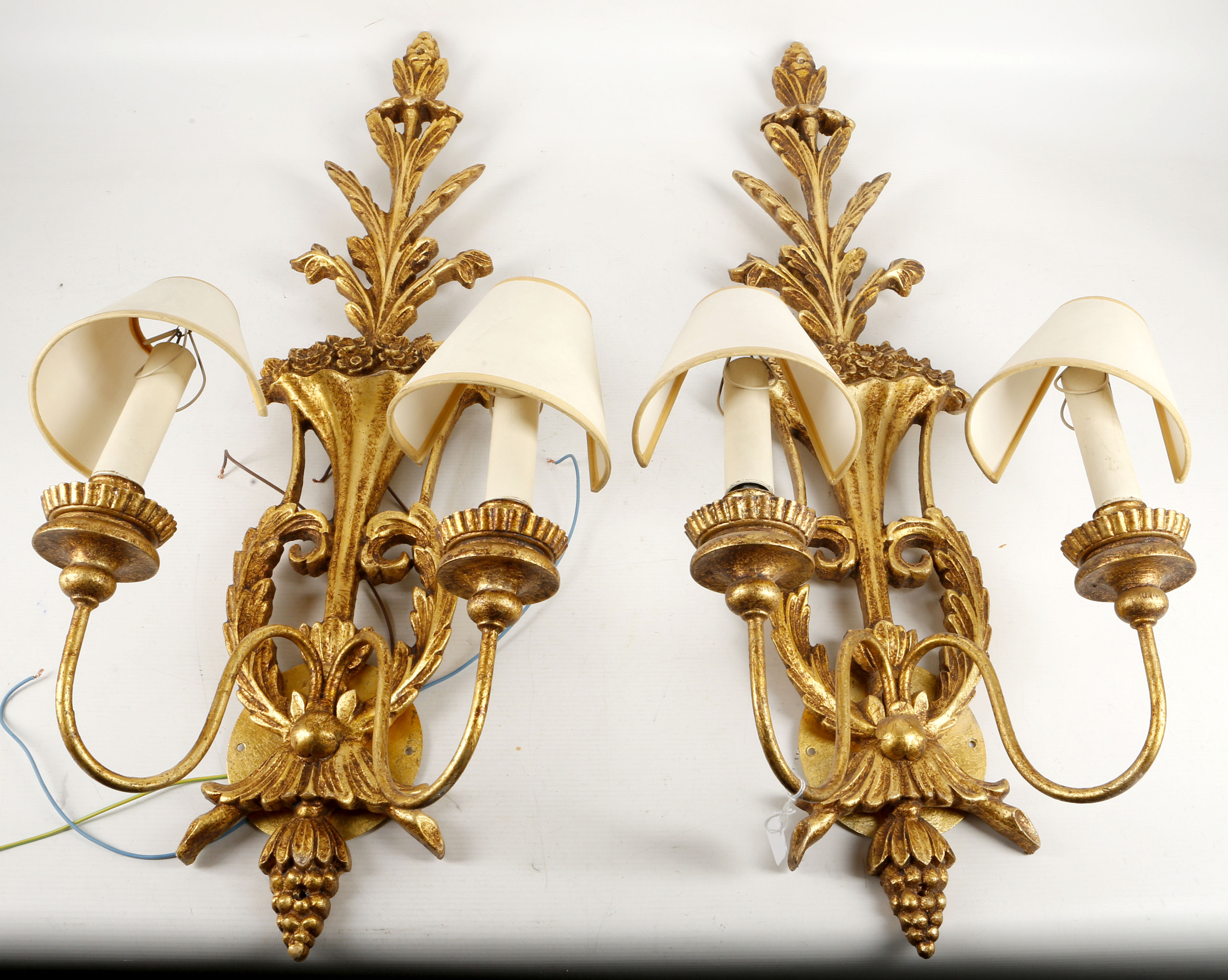 A pair of twin arm girondel wall lights, leaf in t