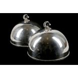 A pair of silver plated domed food covers with zoo