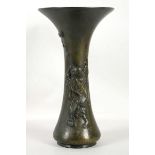 A Japanese bronze vase, decorated with a man playi
