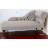 A modern chaise lounge, upholstered in grey linen,