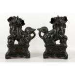 A pair of Chinese black pottery Buddhist lion joss