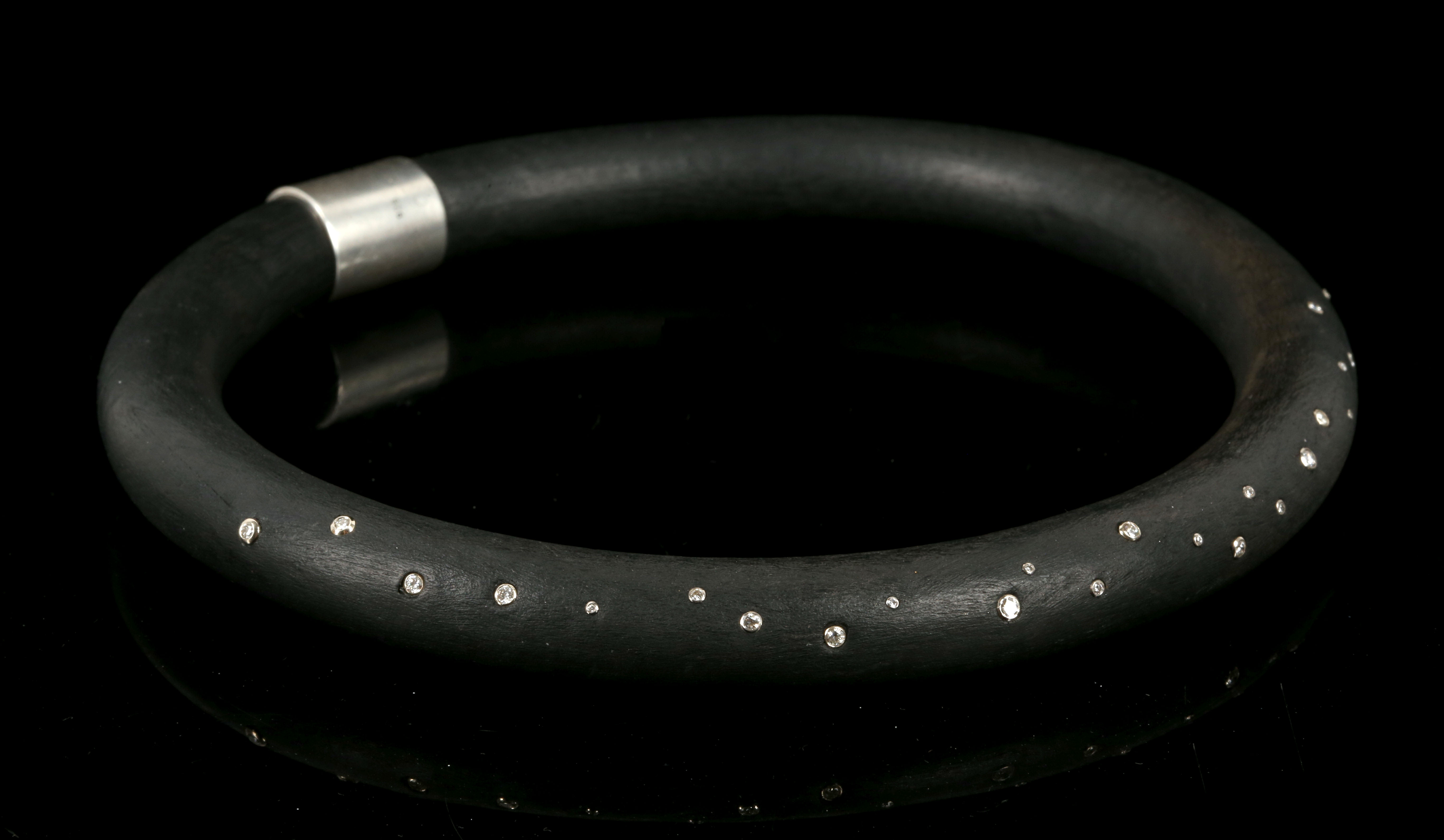 An usual black rubber and diamond set collar with