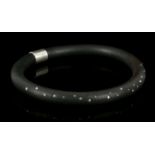 An usual black rubber and diamond set collar with