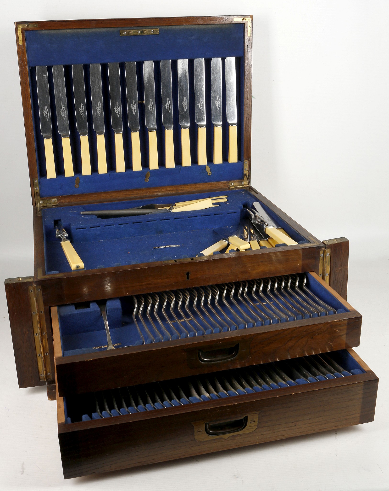 An oak cased Edwardian canteen of cutlery, the kni