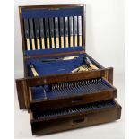 An oak cased Edwardian canteen of cutlery, the kni