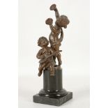 An amusing 19th century, continental bronze group of playful bacchante putties, mounted on marble