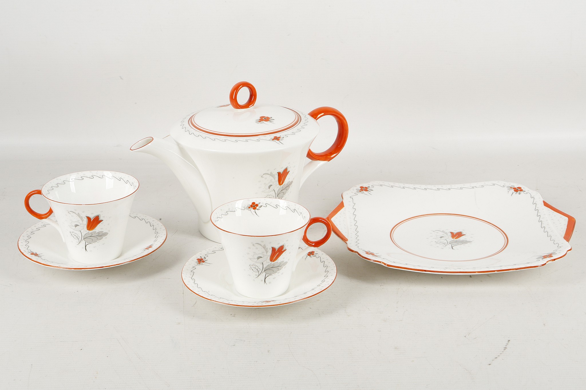 An Art Deco shelly bone chine lète tea service, comprising teapot, two cups and saucers and matching