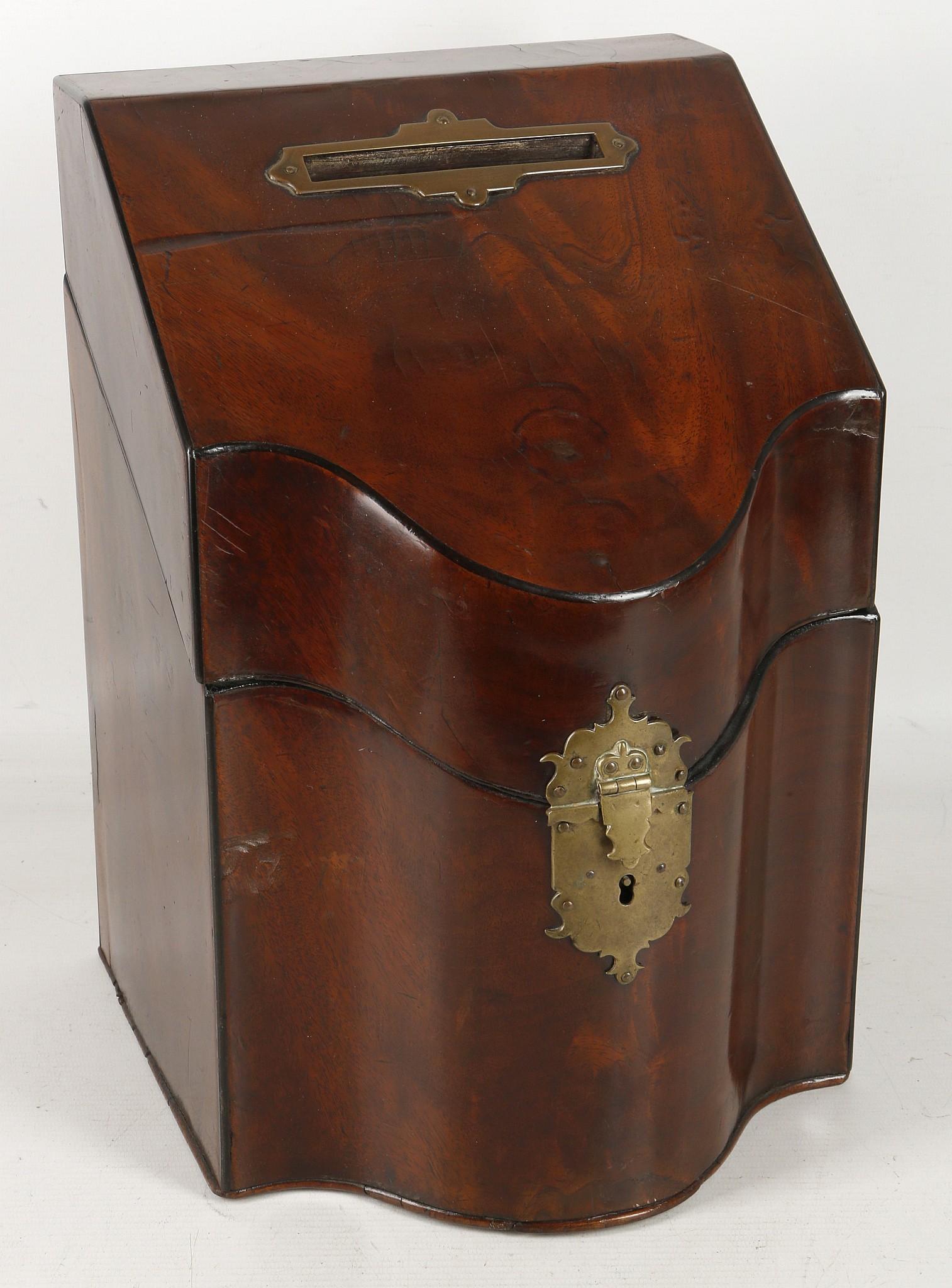 A Georgian mahogany serpentine front knife box, now converted for use as a letterbox, having a brass