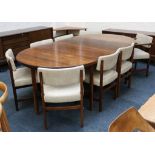 A 1960's rosewood extending dining table and eight chairs, manufactured by Archie Shine, to