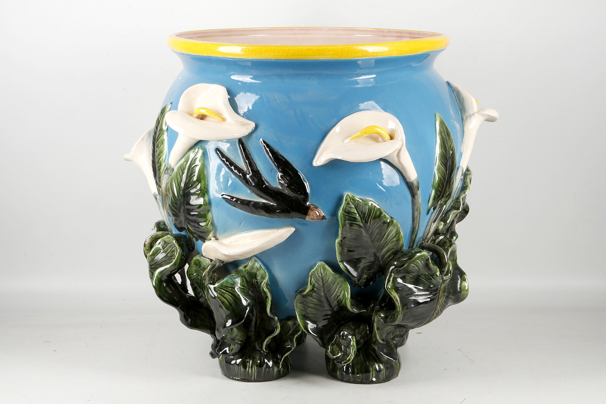 A Majolica style planter, lily and swallow decoration with 'plant' feet, 37cm diameter. - Image 2 of 2