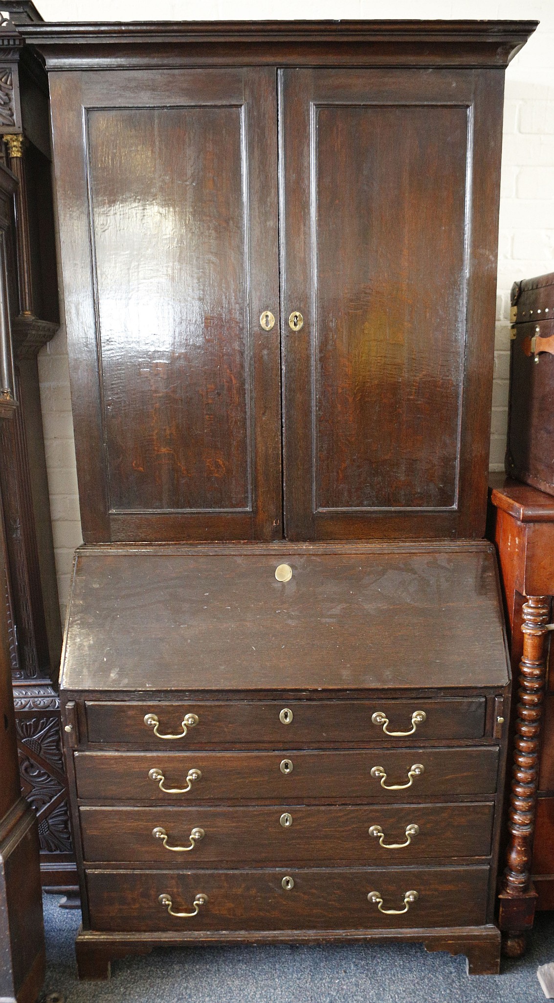 A Georgian bureau bookcase, possibly Irish, solid panel double doors revealing shelving, fall