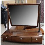 A 19th century mahogany bow fronted dressing table mirror, with three trinket drawers, 54cm.