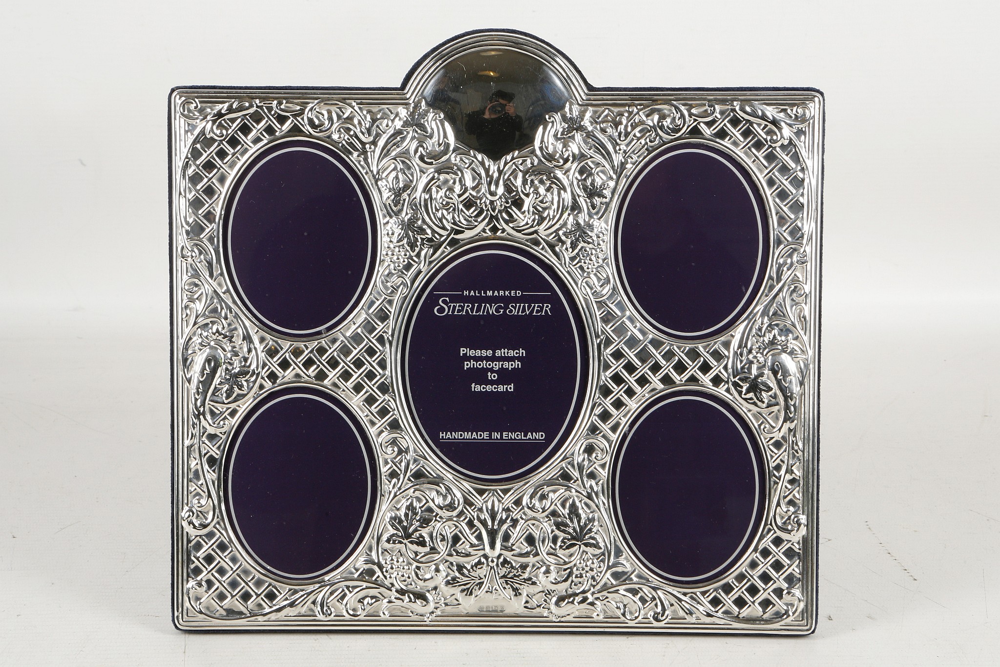 A large fine quality five oval section, hallmarked silver photograph frame, embossed with foliage