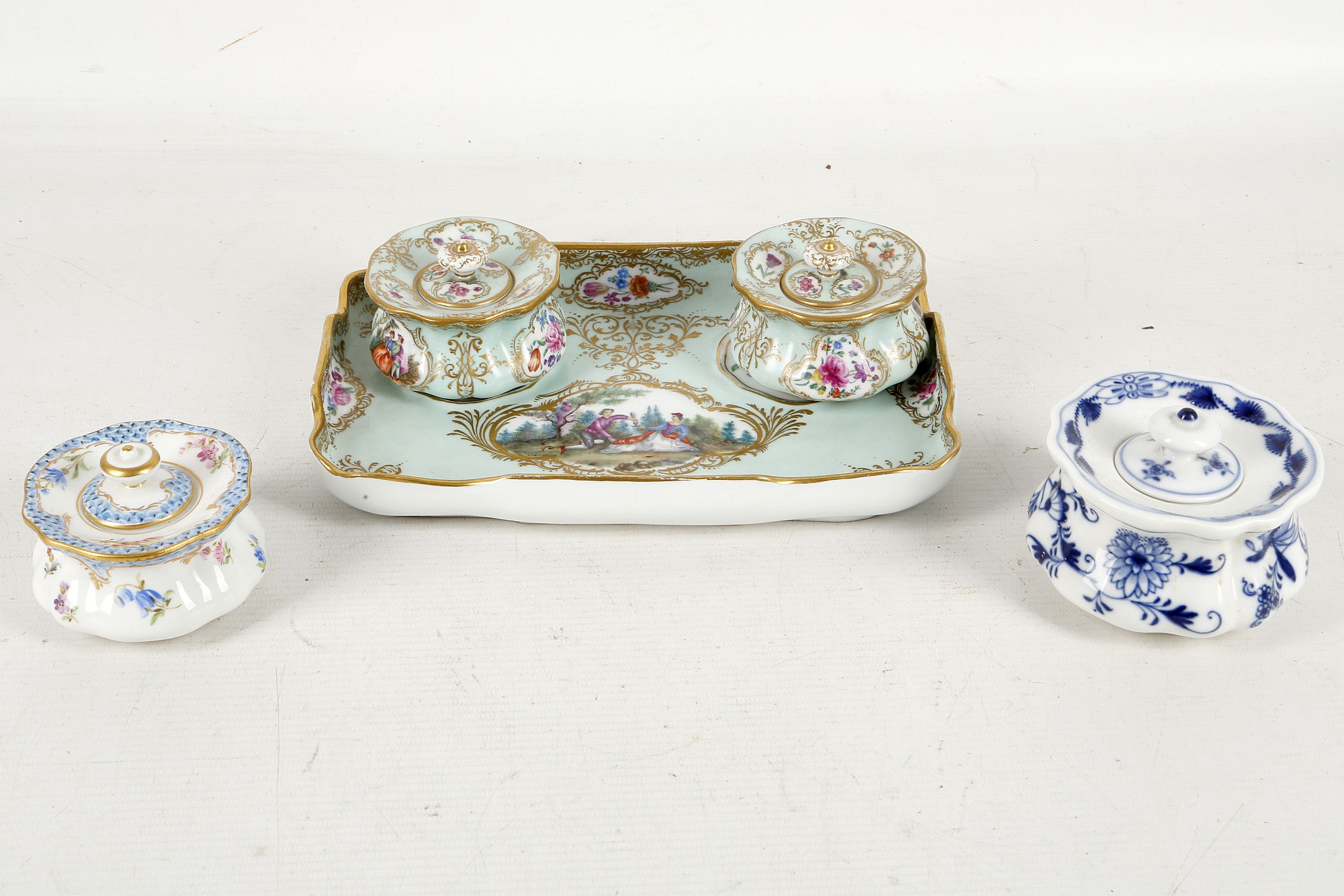 A 19th century Meissen porcelain pair of inkwells on matching trays, pale turquoise ground with