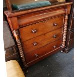 A mahogany chest of drawers, cushion frieze drawer above three long drawers, flanked by turned