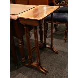 A nest of two rosewood and crossbanded occasional tables with rectangular tops.