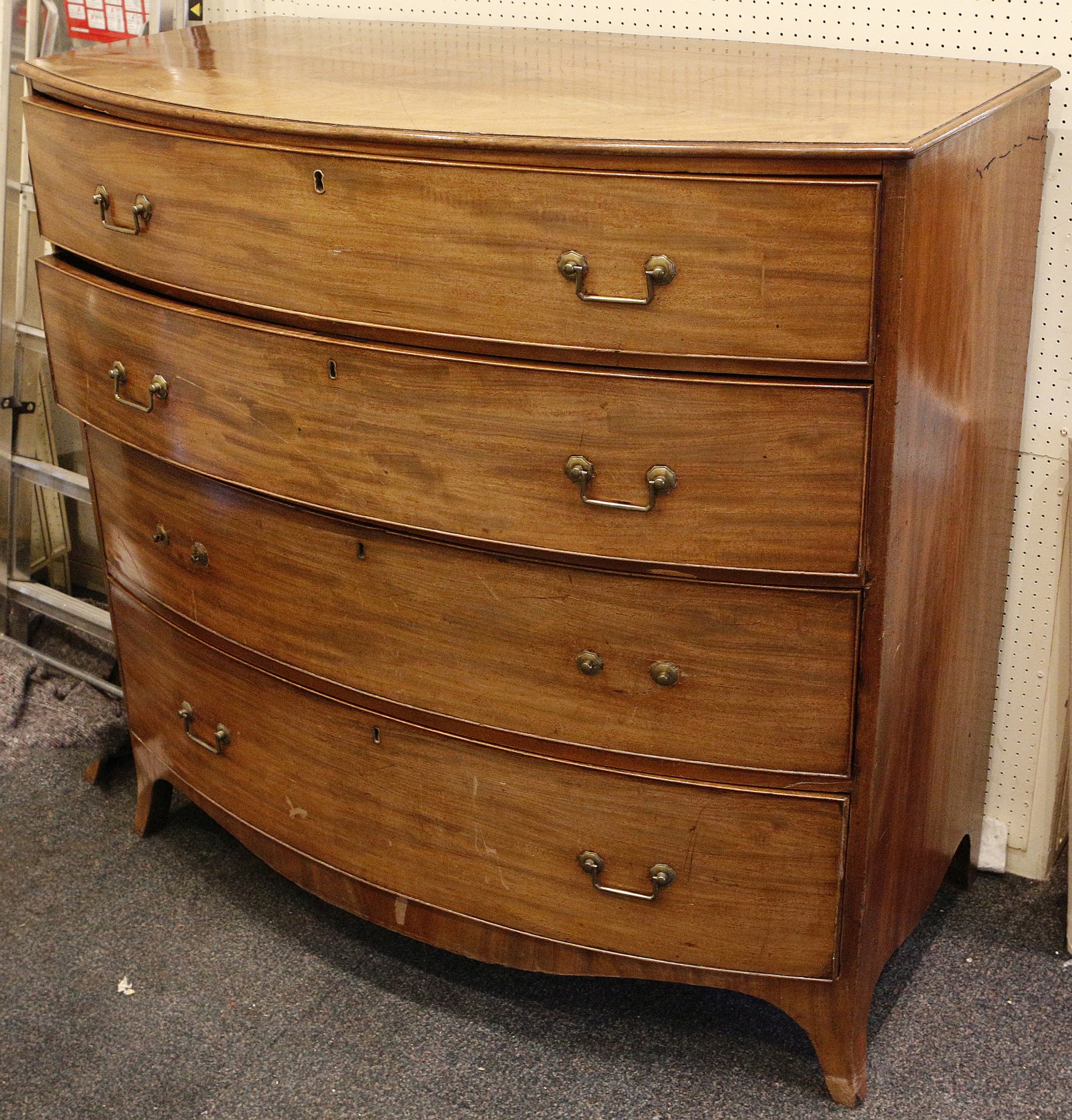 A 19th century mahogany bow fronted chest of drawers, having 4 graduated long drawers, supported