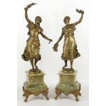 A pair of French 20th century figures, ladies of liberty brandished laurels, gilded spelter on
