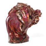 A MODERN CERAMIC SCULPTURE, in the manner of Eric Gill, with dark red lustre glaze, impressed mark