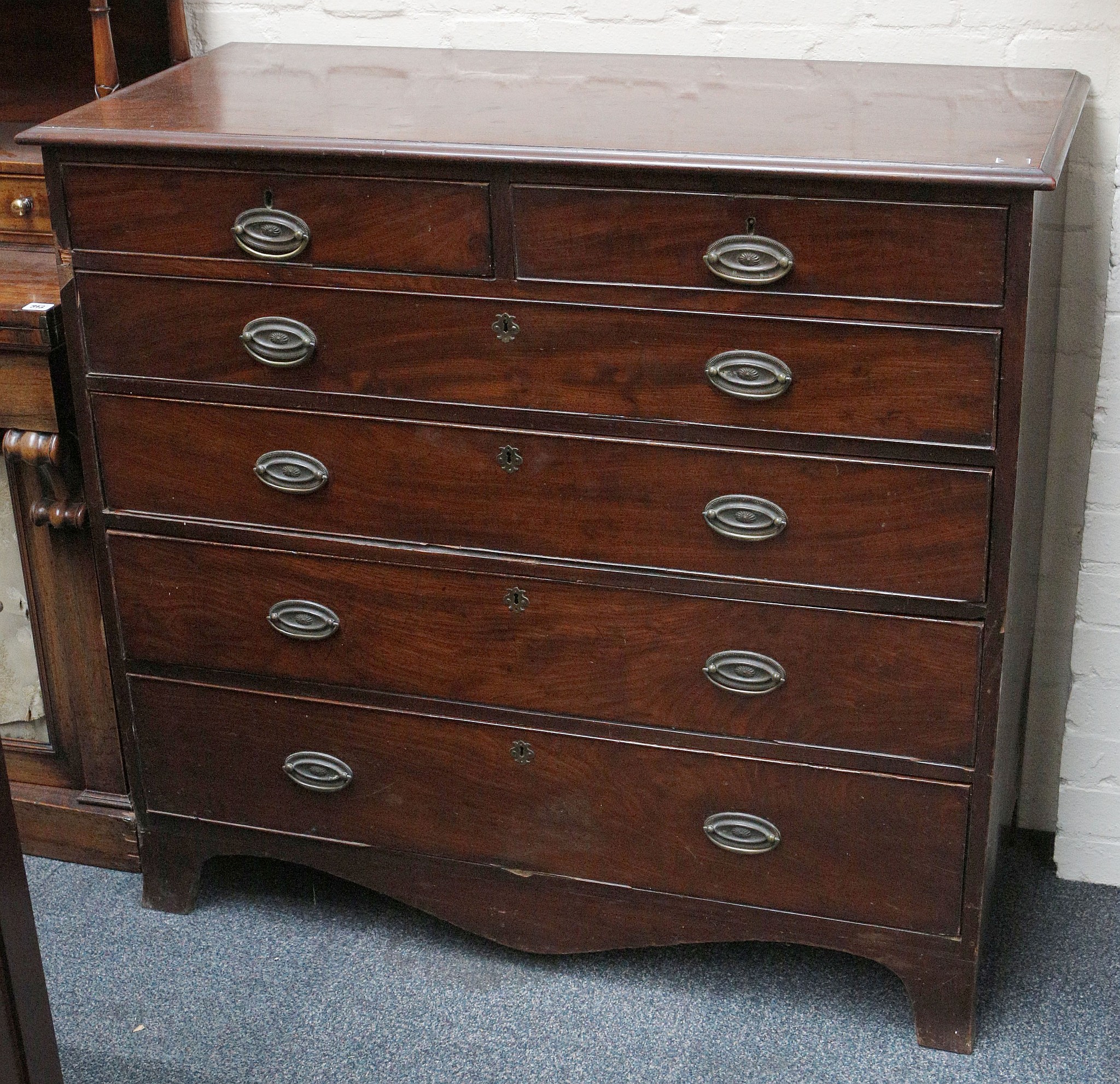 An early 19th century mahogany chest of 2 short over 4 long drawers on bracket feet.